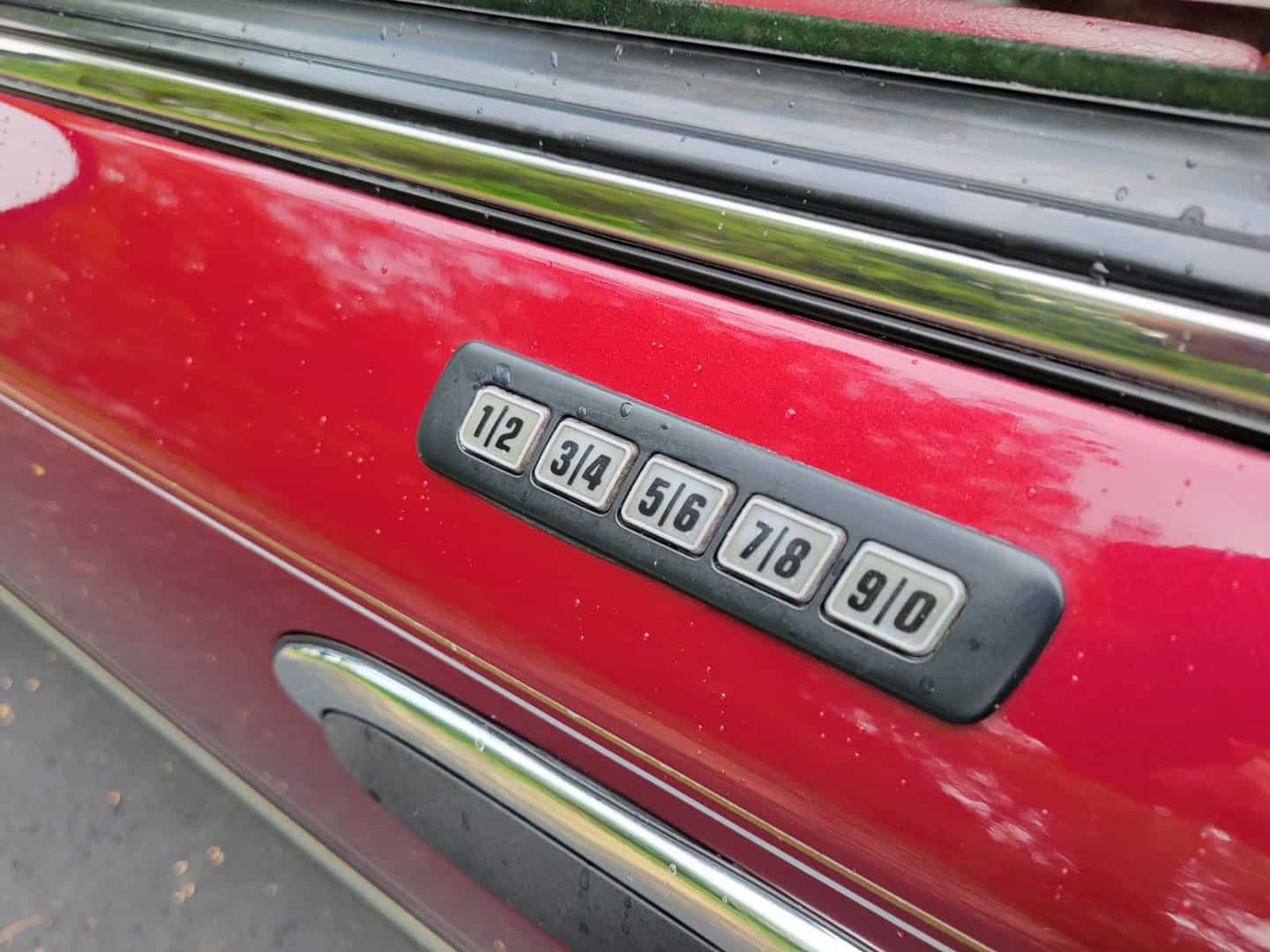 A red car door with a number on it.