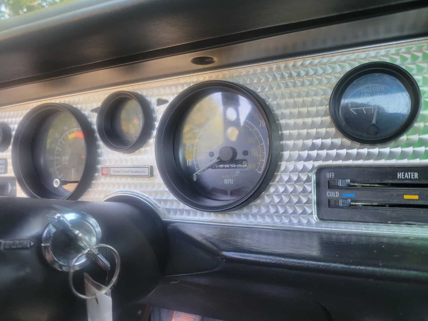 The dashboard of a 1979 Pontiac Firebird with gauges and gauges.