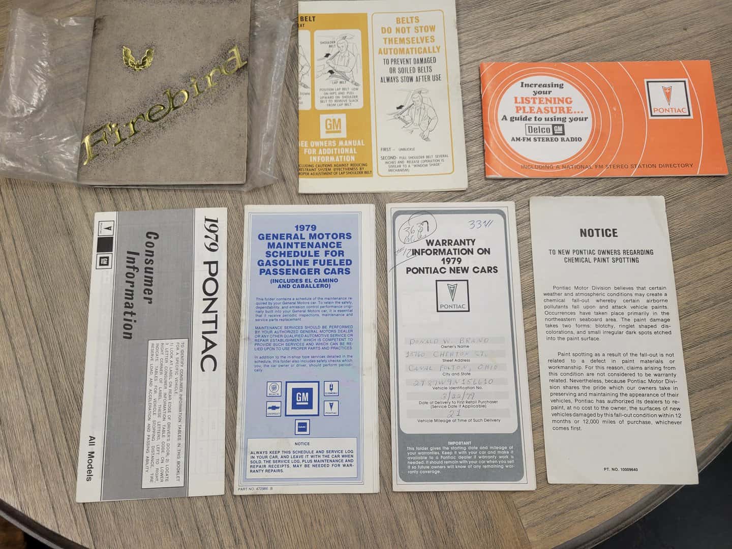 A collection of manuals on a table.
