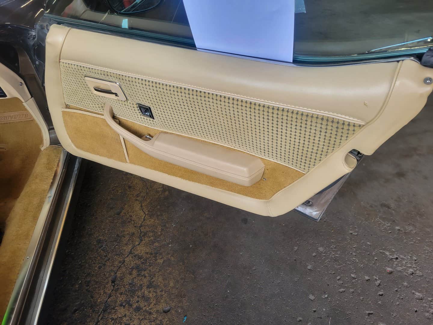 A 1979 Corvette car door with a beige interior.