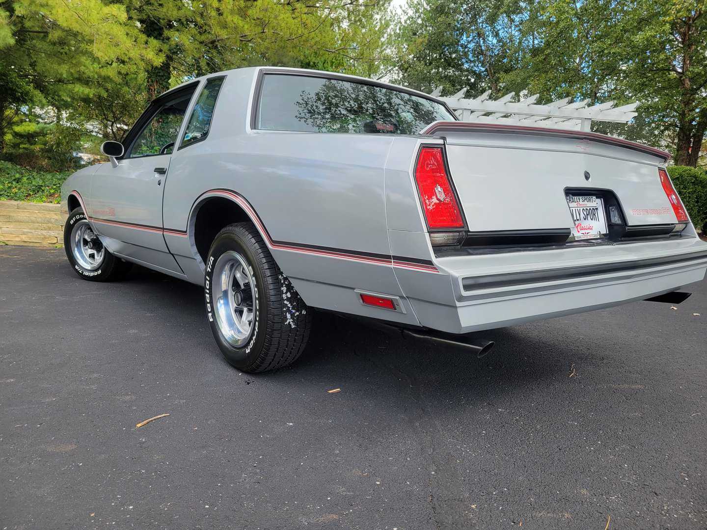 The rear end of a gray 1985 Monte Carlo SS parked in a parking lot.