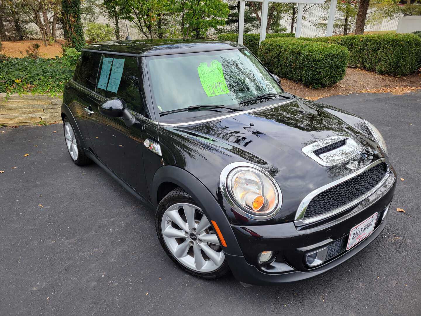 A 2013 black Mini Cooper is parked in a parking lot.