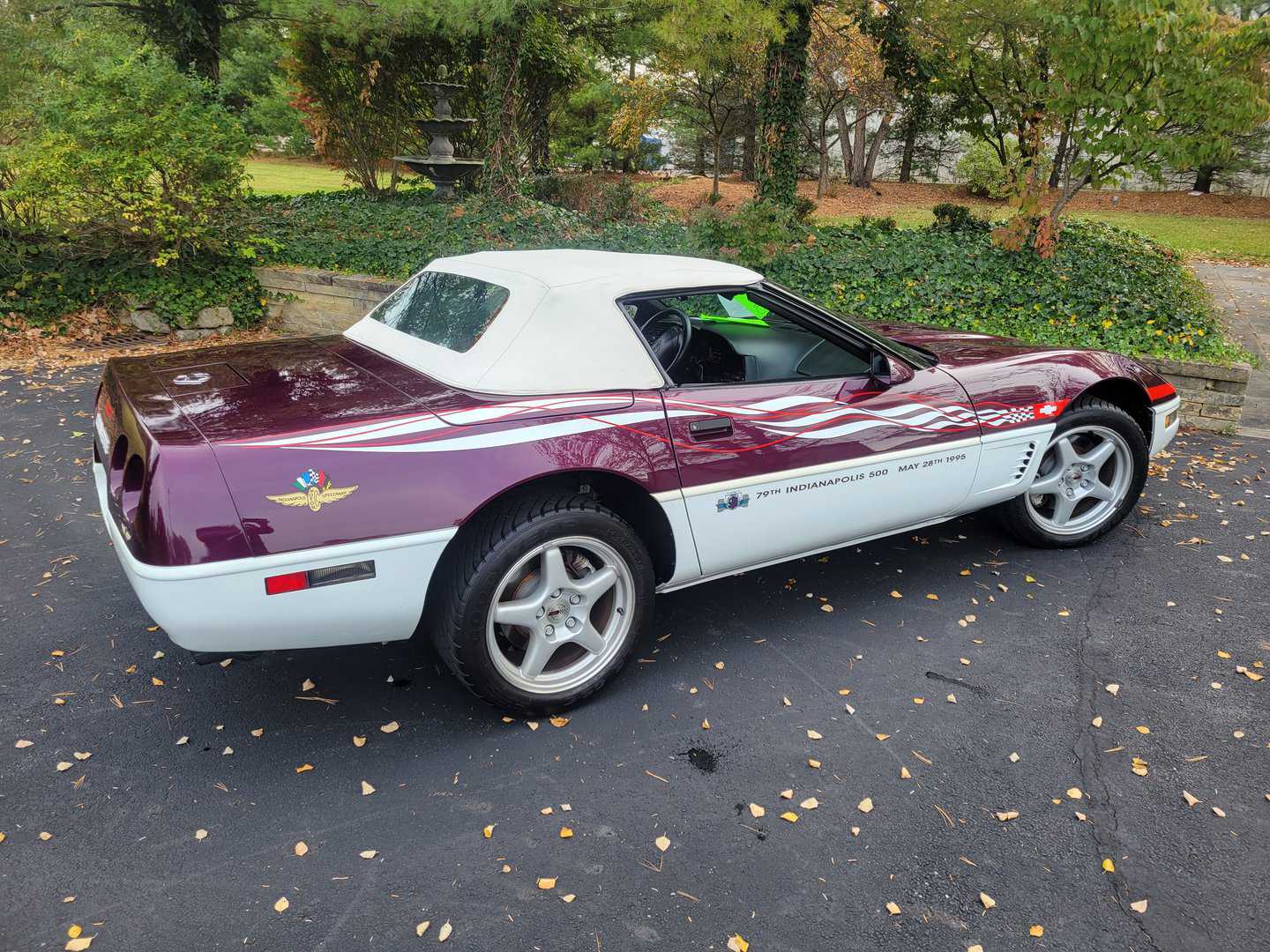 A purple and white 1995 Corvette Pace Car parked in a parking lot.