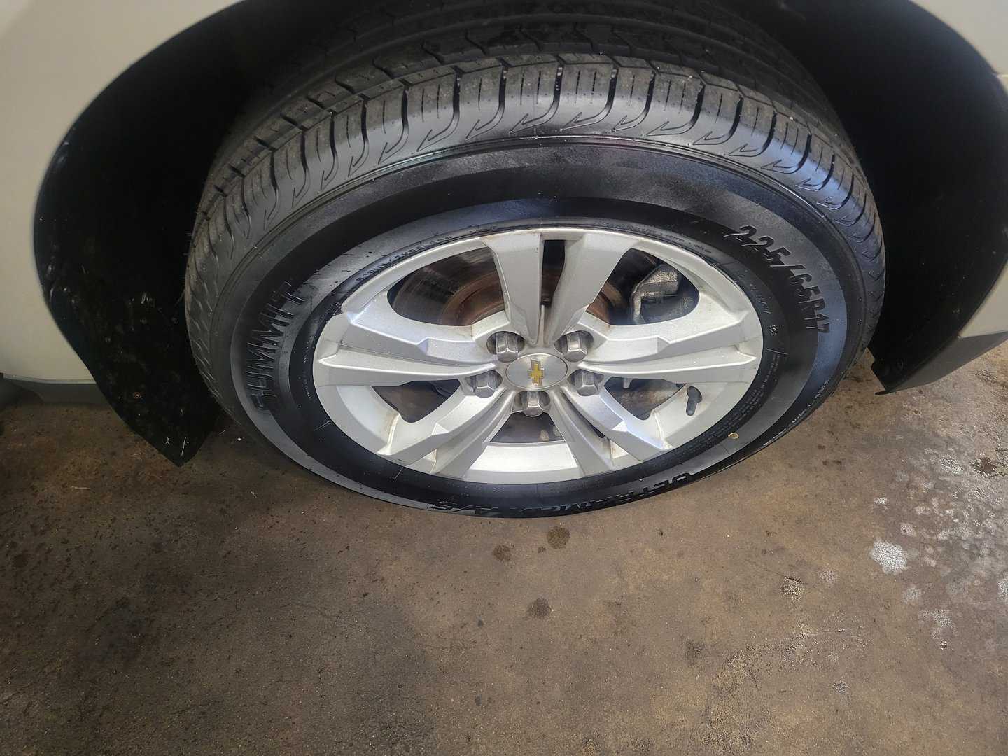 A 2014 Chevrolet Equinox With A Tire On It.