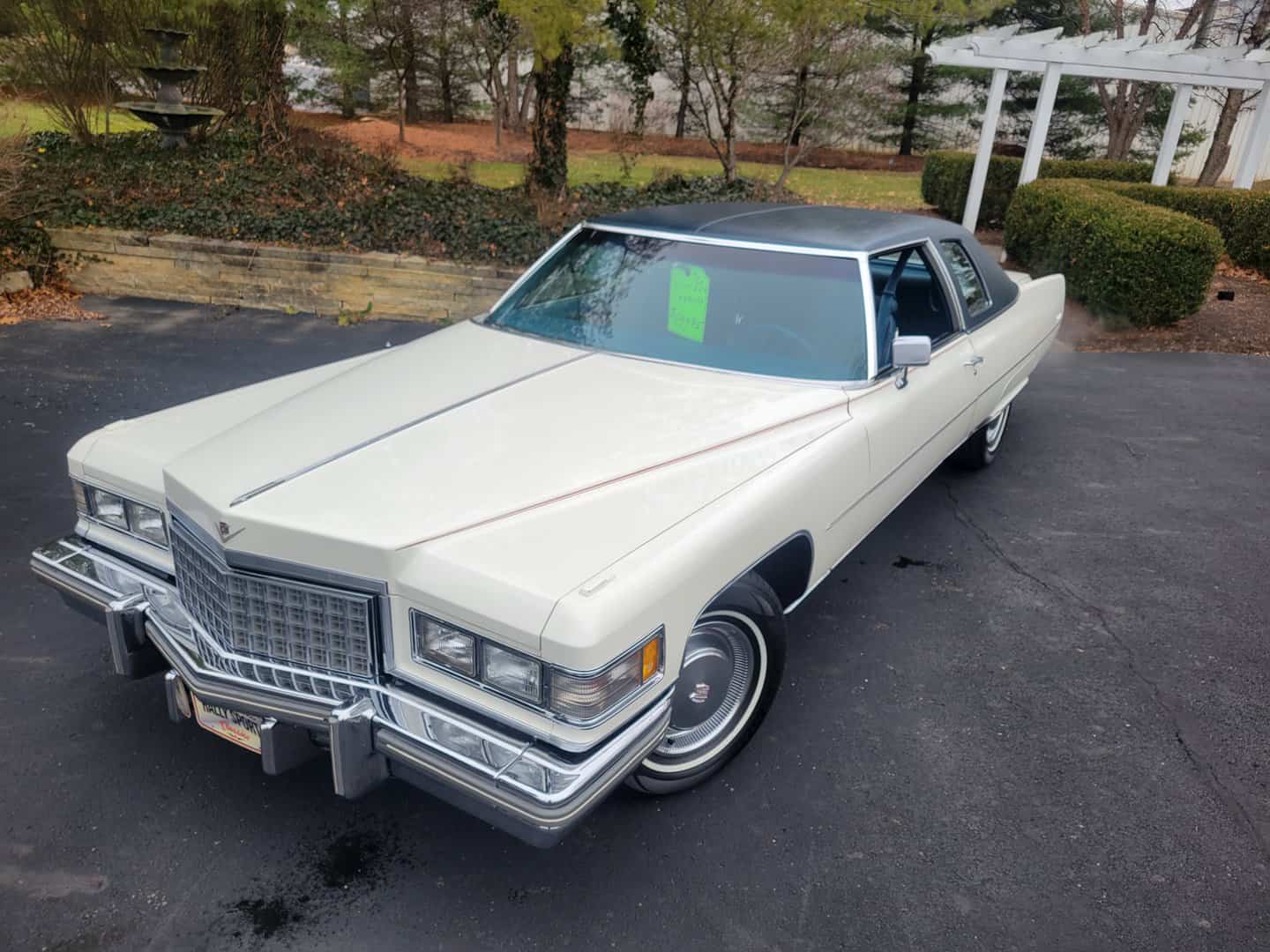 A Vintage 1976 Cadillac Coupe Deville Parked In A Driveway.
