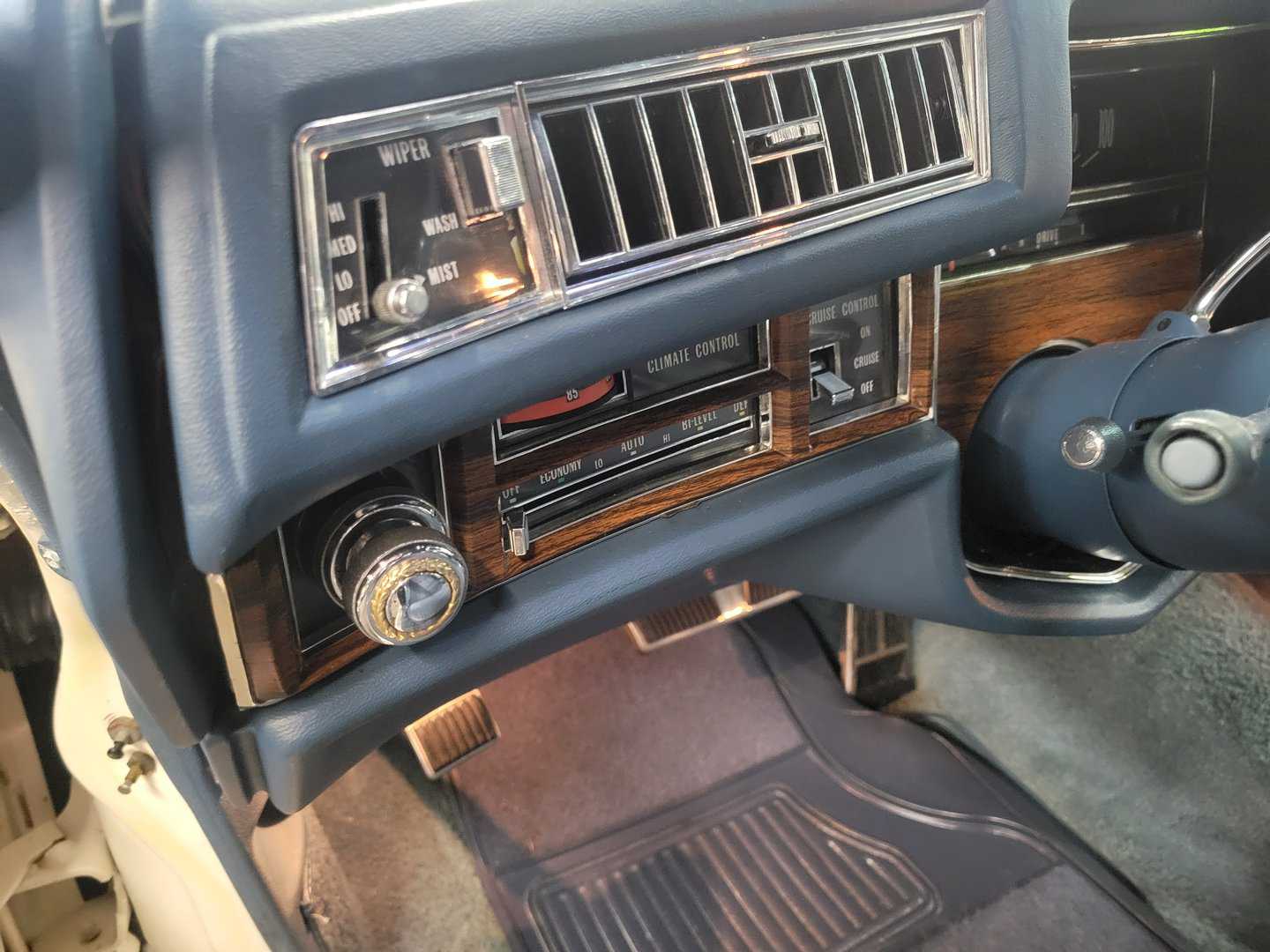 The Interior Of A Cadillac Coupe Deville With An Original Steering Wheel And Radio.
